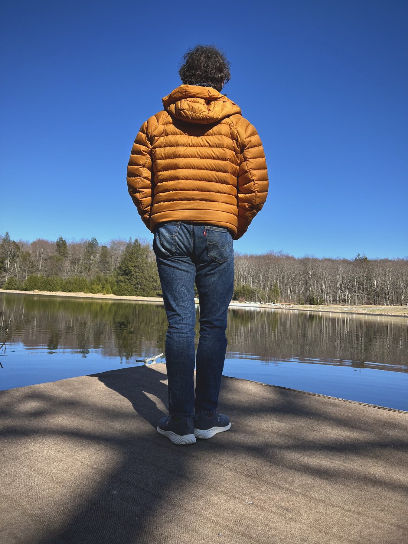 About Robert Sussuma Robert Sussuma facing away, standing next to a lake reflecting on a sunny day.