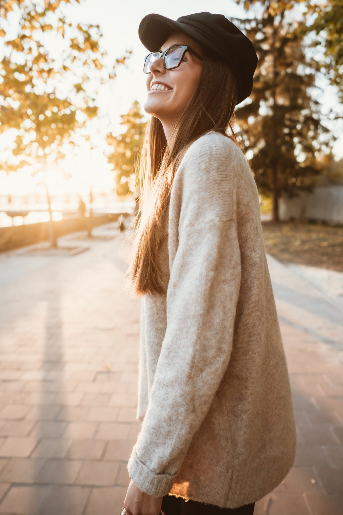Relationship Reset, Be the one. Attractive, young brunette with long hair walking autumn park. She is smiling confidently looking up and walking a confident path in the sunlight.